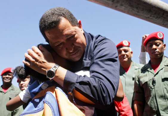 24 hours in pictures: Venezuela's President Chavez hugs a child in Caracas