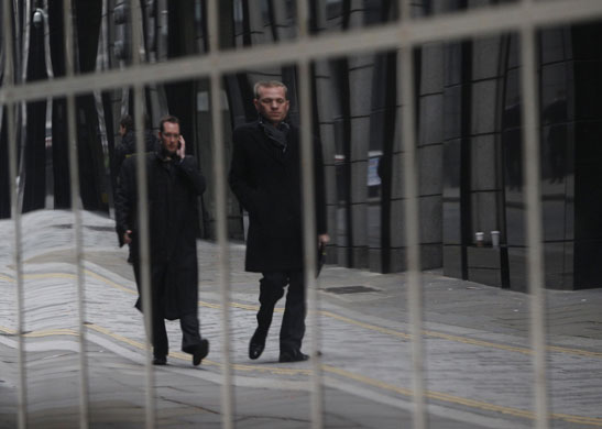 Week in Business: Pedestrians are reflected in the Goldman Sachs building in London