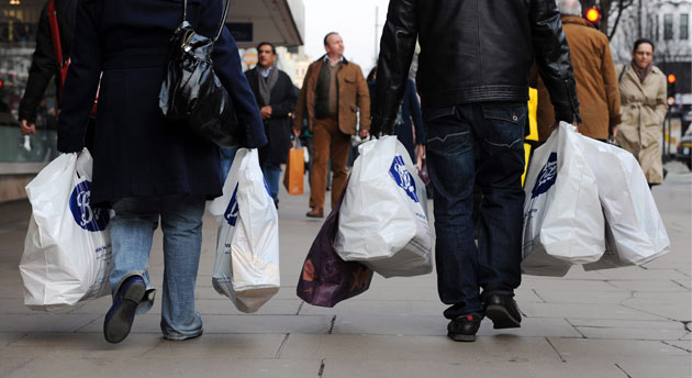Week in Business: Shoppers carry their shopping bags along Oxford street in London