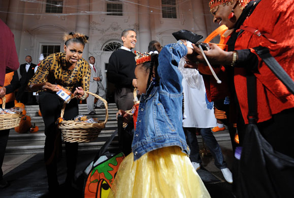 Michelle Obama: Barack and Michelle Obama greet trick or treaters at the White House