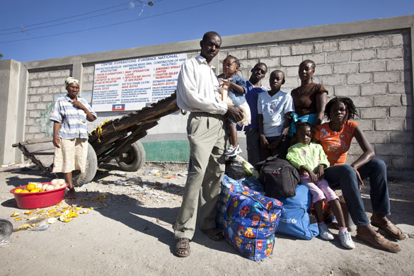 Haiti looting/bus station: The Georges family wait for a bus