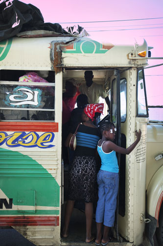 Haiti looting/bus station: At Delmas bus station families board a bus