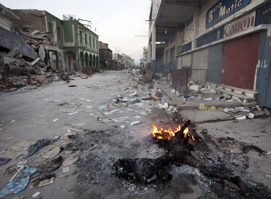 Haiti looting/bus station: The body of an unknown Haitian burns