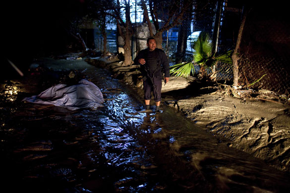 24 hours in pictures: Tijuana, Mexico: A police officer guards the body of a girl