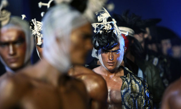 24 Hours in Pictures: Models wear creations by British fashion designer John Galliano in Paris