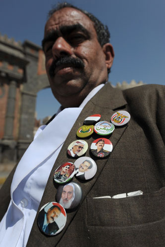 Yemen : A man wears badges in Old City of Sana'a Yemen