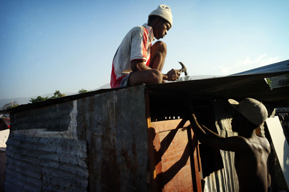 Camps in Haiti: Men build a hut in the  Delmas stadium in Port-au-Prince 