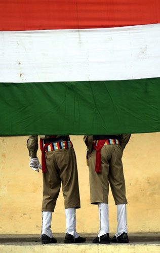 24 hours in pictures: Amritsar, India: Two military cadets stand behind the national flag