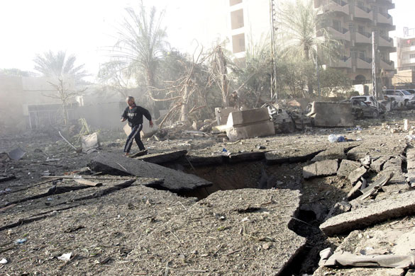 bombs in  baghadad: bomb crater  after a suicide car bomb attack in Baghdad