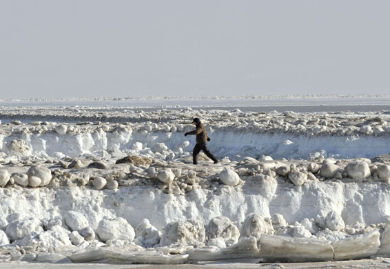 24 hours in pictures: A man walks on the frozen sea near Liaodong Bay , China
