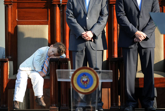 24 hours in pictures: The son of Tegucigalpa's Mayor sleeps during a swearing in ceremony 