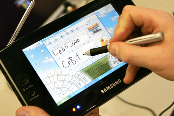 Tablet computers: 2006 A Microsoft hostess presents a Ultra Mobile Personal Computer tablet