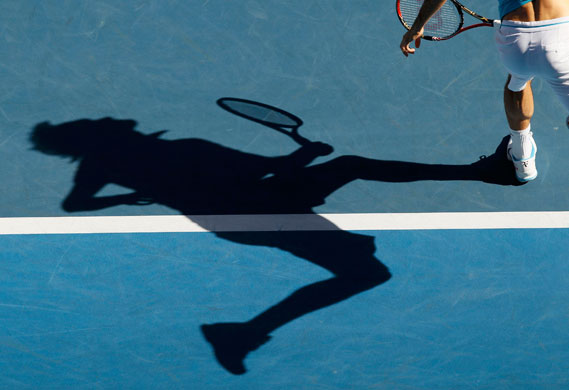 Aus Open Day 10: Roger Federer of Switzerland chases the ball