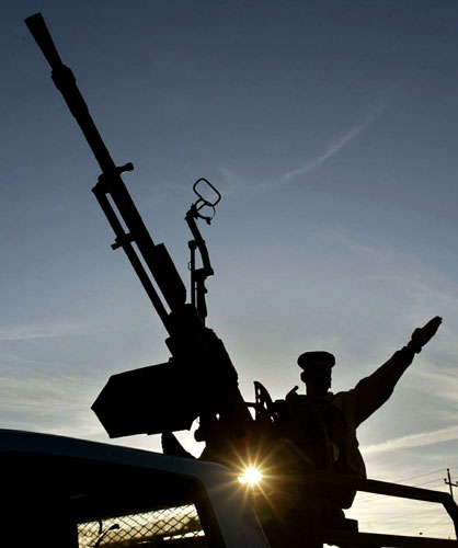2003 Three Months to war: An Iraqi soldier salutes volunteers