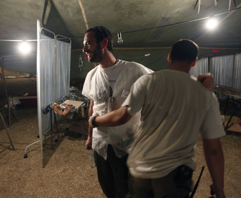 Haiti's survivors: 22 January: The feet of patient Emmannuel Buso are seen in the background