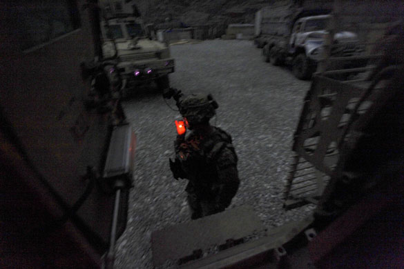 24 hours in pictures: Pech Valley, Afghanistan: As darkness falls a US soldier smokes a cigarette