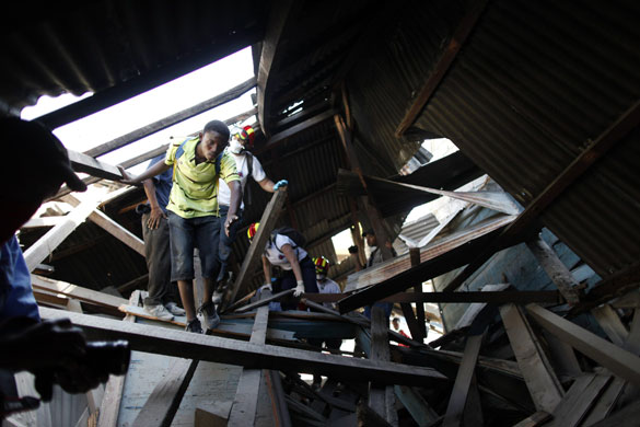 Haiti's survivors: 23 January: Members of a rescue team search for survivors