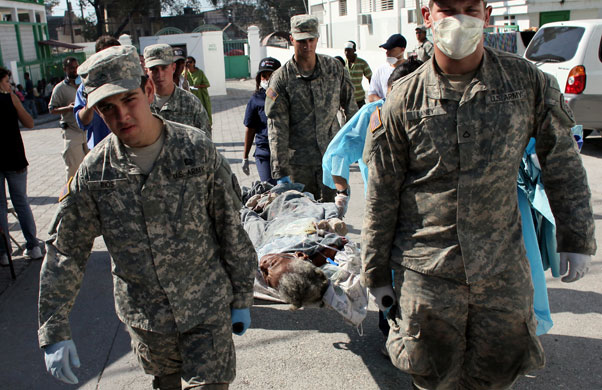 Haiti's survivors: 22 January: US marines carry Marie Carida Roman
