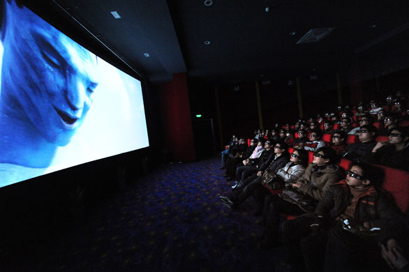 Week in business: Chinese cinemagoers wear 3D glasses as they watch Avatar