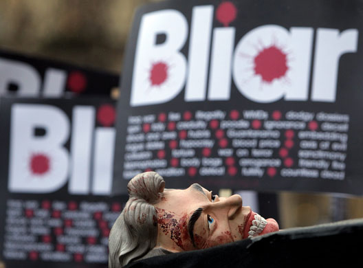 Anti-Blair protests: A protester's Tony Blair face mask outside the Queen Elizabeth II Centre