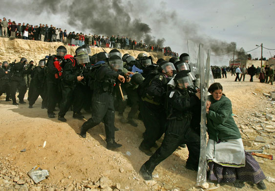 Pictures of the decade: A Jewish settler struggles with an Israeli security officer in Amona