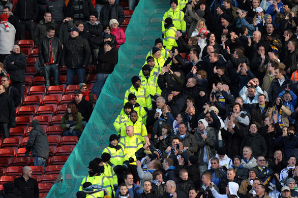 FA cup 3rd round: Manchester United, left, and Leeds United supporters are kept apart 