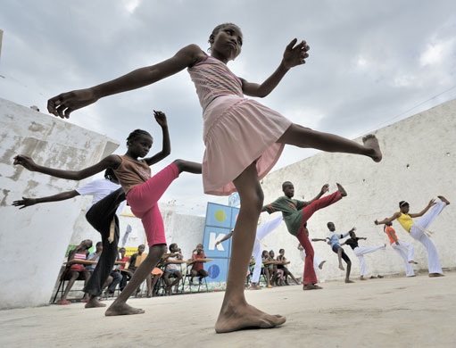 24 Hours in Pictures: Haitian children practice capoeira at a camp for homeless families
