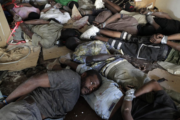 24 Hours in Pictures: Suspected looters lay with their hands tied after being detained in Haiti