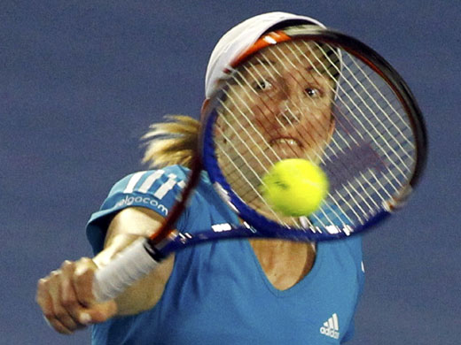 Aussie Open Women's Final: Henin returns a shot against Williams 