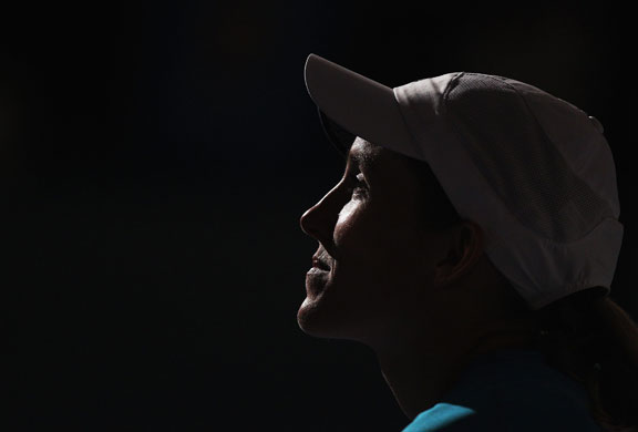 Aussie Open Women's Final: A rueful Justine Henin looks on as Serena collects the trophy