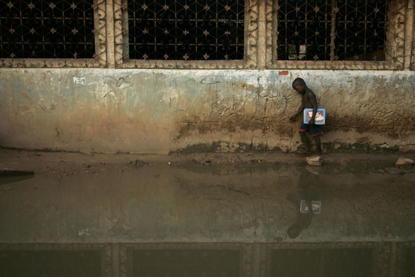 24 hours in pictures: An Angolan child crosses a flooded street in a suburb of the capital Luanda