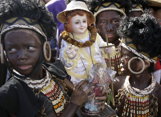 24 hours in pictures: Statuette of Child Jesus during a religious procession in Manila