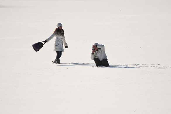 snow in korea and china: Beijing, China: Tourists take photos on a snow-covered frozen lake