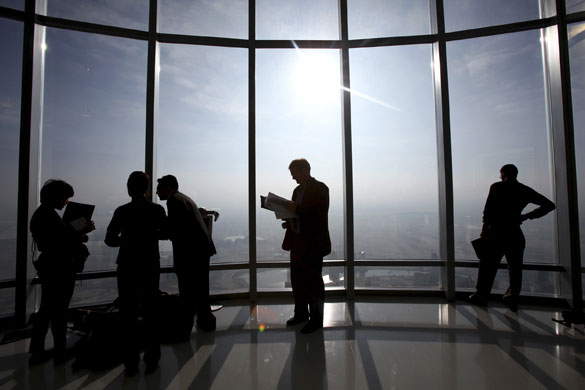 Burj Dubai: Members of the media look out from one of the observation decks
