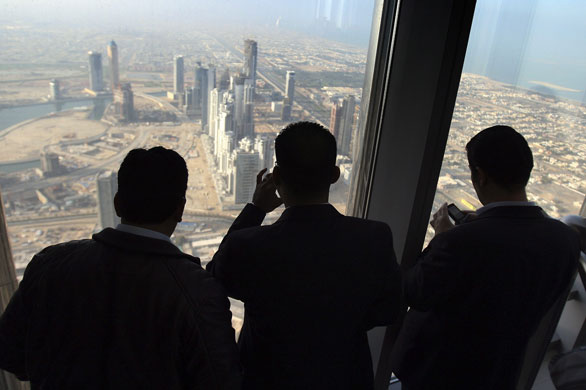 Burj Dubai: Members of the media look at the view of Dubai city from the 124th floor