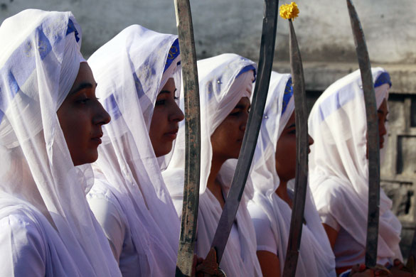 24 hours in pictures: Bhopal, India: Sikh women devotees hold religious swords