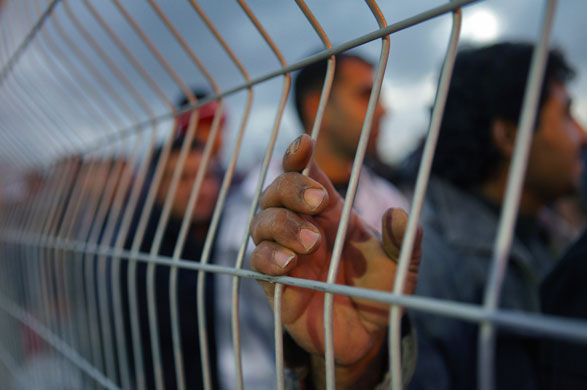 24 hours in pictures: Ni'ilin, West Bank: Palestinian labourers line up to cross acheckpoint