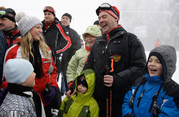 Putin and Medvedev: Dmitry Medvedev smiles as he chats with children in Krasnaya Polyana
