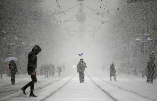 24 hours: People walk during a heavy snowfall in the centre of Sofia