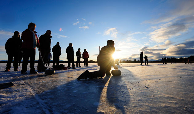 Snow: A curler tests the ice on Lake of Menteith