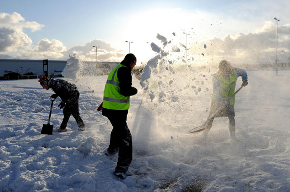 Winter weather: Staff take time out from clearing the car parks to have a snow fight