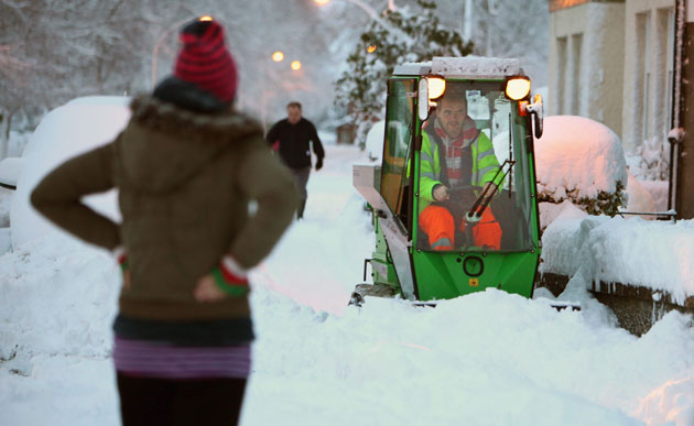 Winter weather: St Boswells, Scotland, January 6:  A man tries to clear a pavement