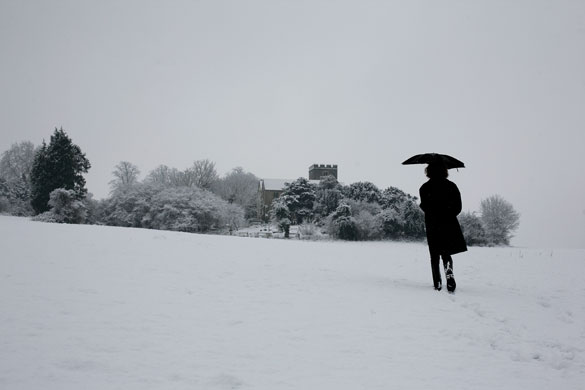 Winter weather: Addington, Kent, 6 January: A woman walks in a snow shower