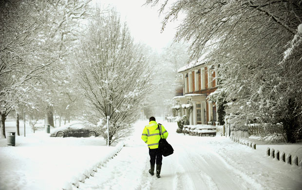 Winter weather: Hartley Wintney, Hampshire: An ambulance man walks away 