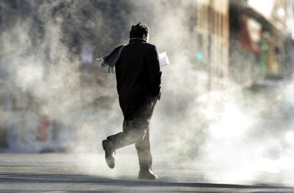 24 hours in pictures: St. Louis, USA: A man hurries across street in freezing conditions