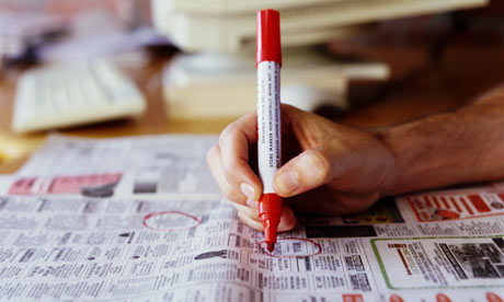 A man circles job ads