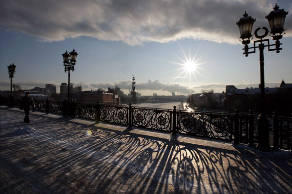 Northern hemisphere: Moscow, Russia: The sun illuminates a bridge during sunset