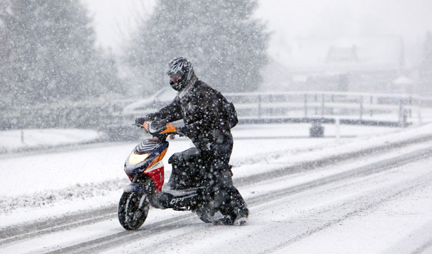Northern hemisphere: Berkel en Rodenrijs, The Netherlands: A person on a scooter struggles