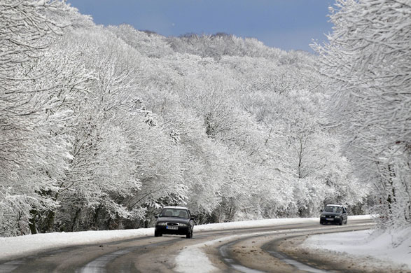 Northern hemisphere: Cherbourg, France: Cars drive as snow and ice cause traffic problems