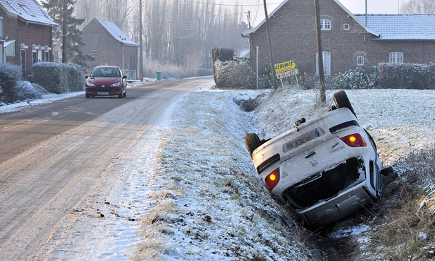 Northern hemisphere: Lorgies, France: An overturned car on the side of a snow-covered road